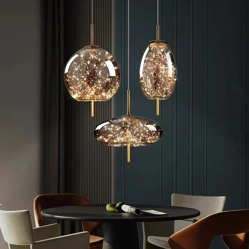 Astrelle Starlit Glass Pendant Light – lifestyle over dining table, Sphere Saucer and Oval shapes