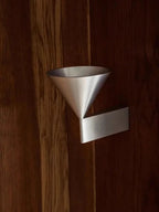Elrovan wall sconce, silver, detail on wood panel