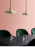 Raelith White Marble pendant lights over a dining setting