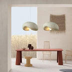 Tempero — two stone grey dome pendants above a terracotta dining table in a Japandi interior with wheat field view