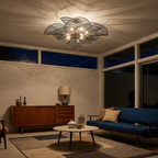 Igronex sculptural pleated ceiling light in black, illuminated at night, dramatic ceiling shadow pattern