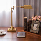 Talvern antique brass articulated desk lamp — Rectangular Shade, on wood desk with books
