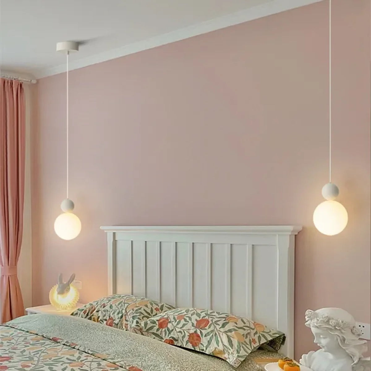 Luniva mini pendant lights in pairs above a headboard