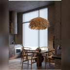 Ntavero handwoven rattan dome pendant light with shaggy natural straw texture hanging against neutral background