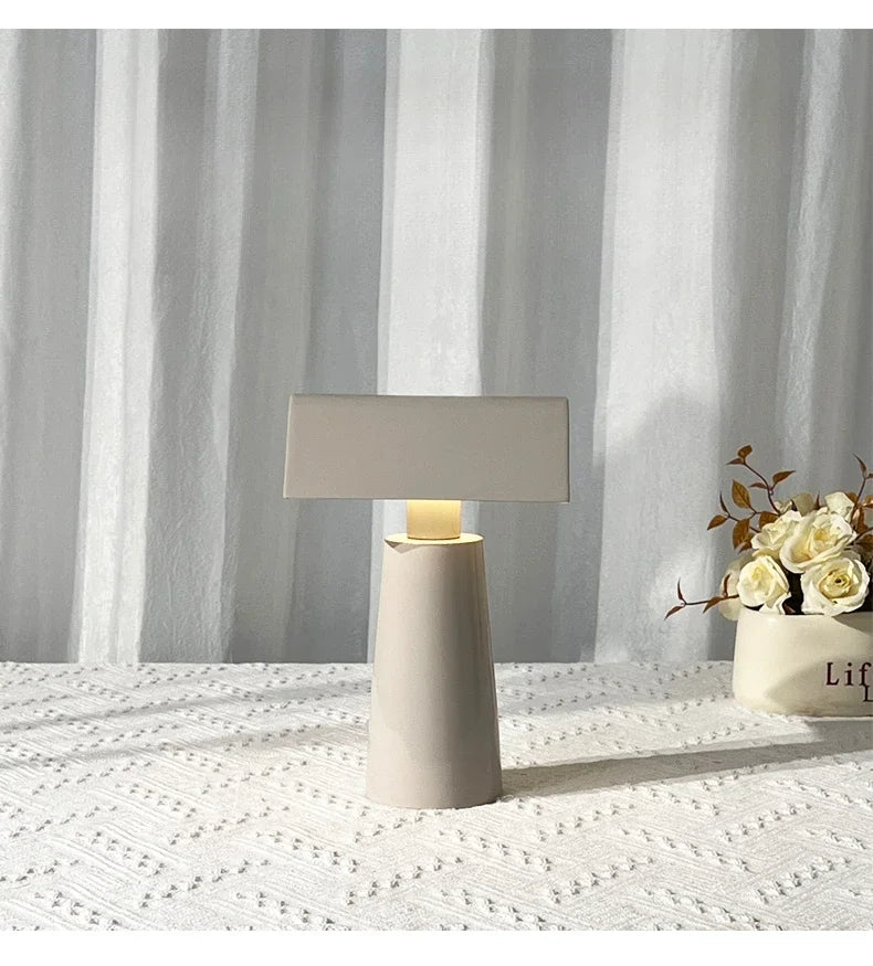 Cordless banker-style table lamp in milk gray with fresh flowers
