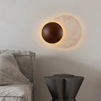 Sculptural Eclipse Wall Sconce Umbrion — living room view (alt angle)