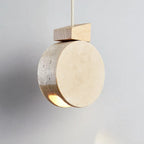 Marevaux travertine stone disc pendant light, lit, hanging view