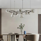 Stellarix Bubble Cluster Chandelier, 9-head transparent glass, above a dining table