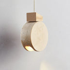 Marevaux travertine disc pendant, close-up angle showing warm edge-lit glow
