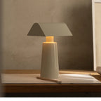 Cordless banker-style table lamp in milk gray on a writing desk