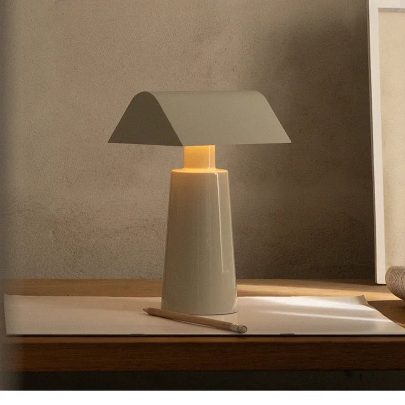 Cordless banker-style table lamp in milk gray on a writing desk