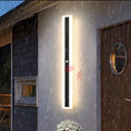 Veltora outdoor wall light with PIR motion sensor lit in the rain, IP65 rated