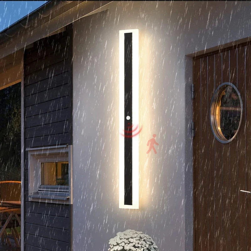 Veltora outdoor wall light with PIR motion sensor lit in the rain, IP65 rated