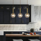 Modern Glass Globe Pendant Light Hovrix - Single Pendant, Gold & Clear Glass, in a kitchen island