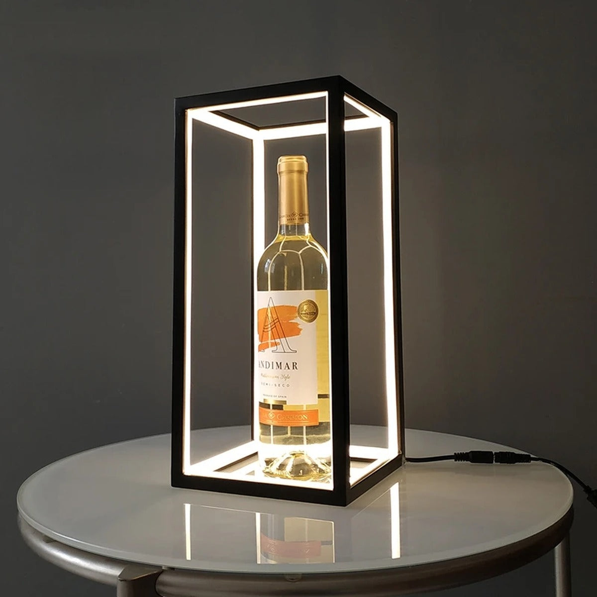 Welion wireframe lamp doubling as an illuminated display case on a round glass side table
