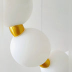 Close-up of opal acrylic bead and brushed gold connector detail on Halmira pendant