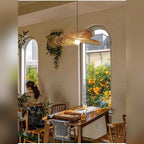 Handwoven Rattan Wing Pendant Light Mtavion – Lifestyle in café setting