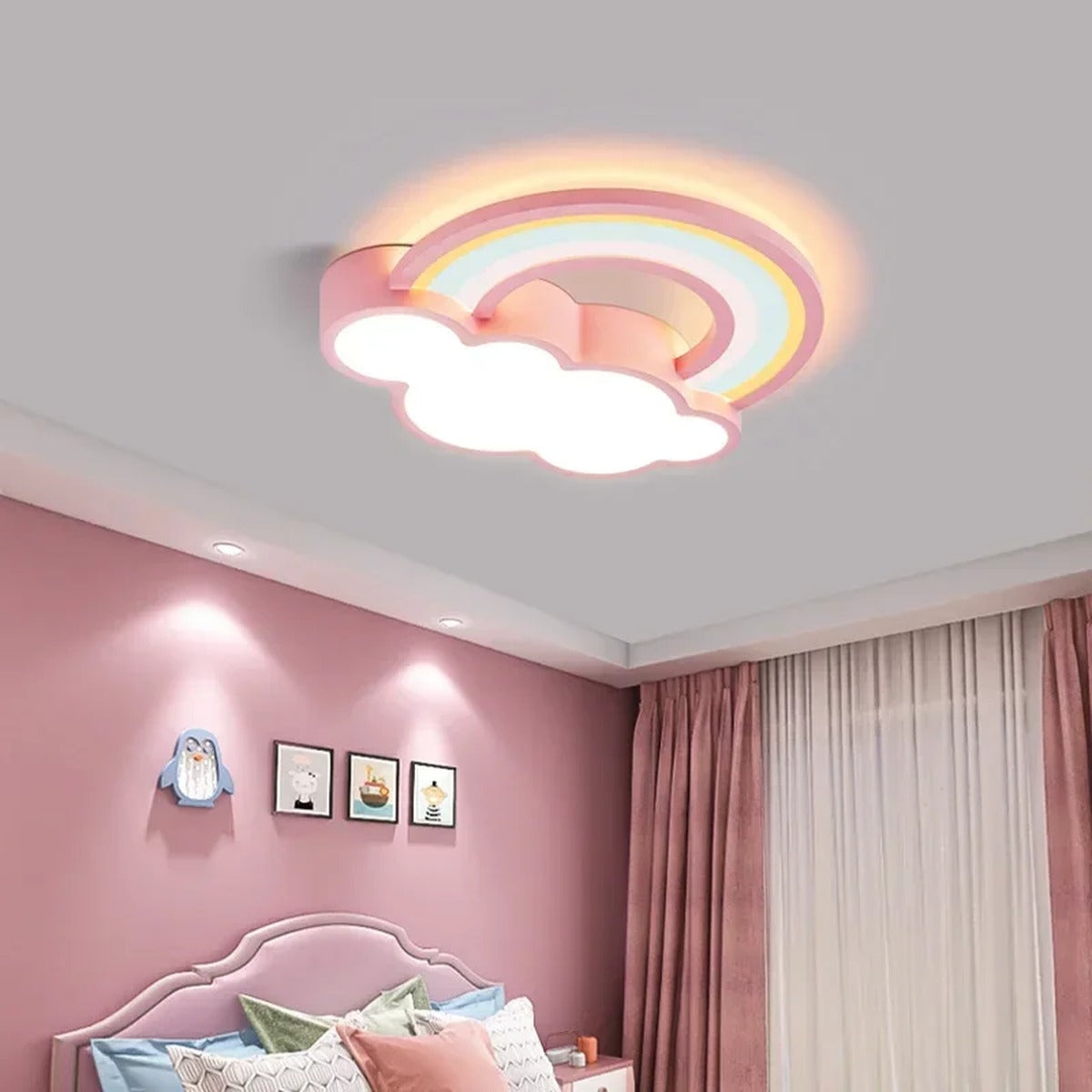 Quieton pastel rainbow and cloud LED ceiling light in a pink child bedroom
