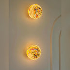 Two Orbinth wall sconces mounted vertically on a plain wall