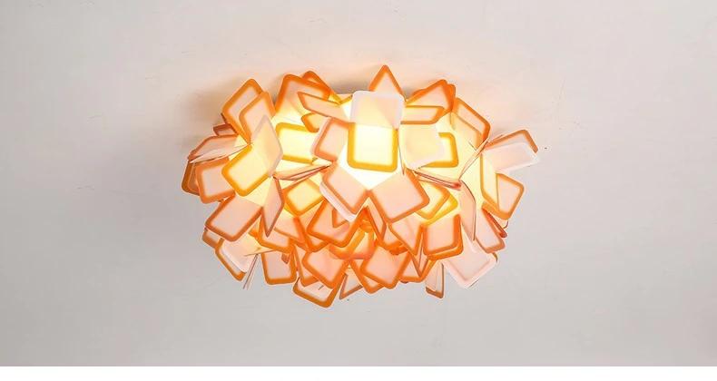 Lumero chandelier, orange-edge acrylic petals, illuminated