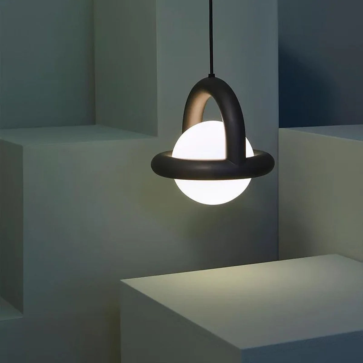 Orbivex matte arc ring pendant — black arc with opal globe in sculpted architectural space