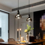 Torvalis smoked glass pendant lights above a dining table