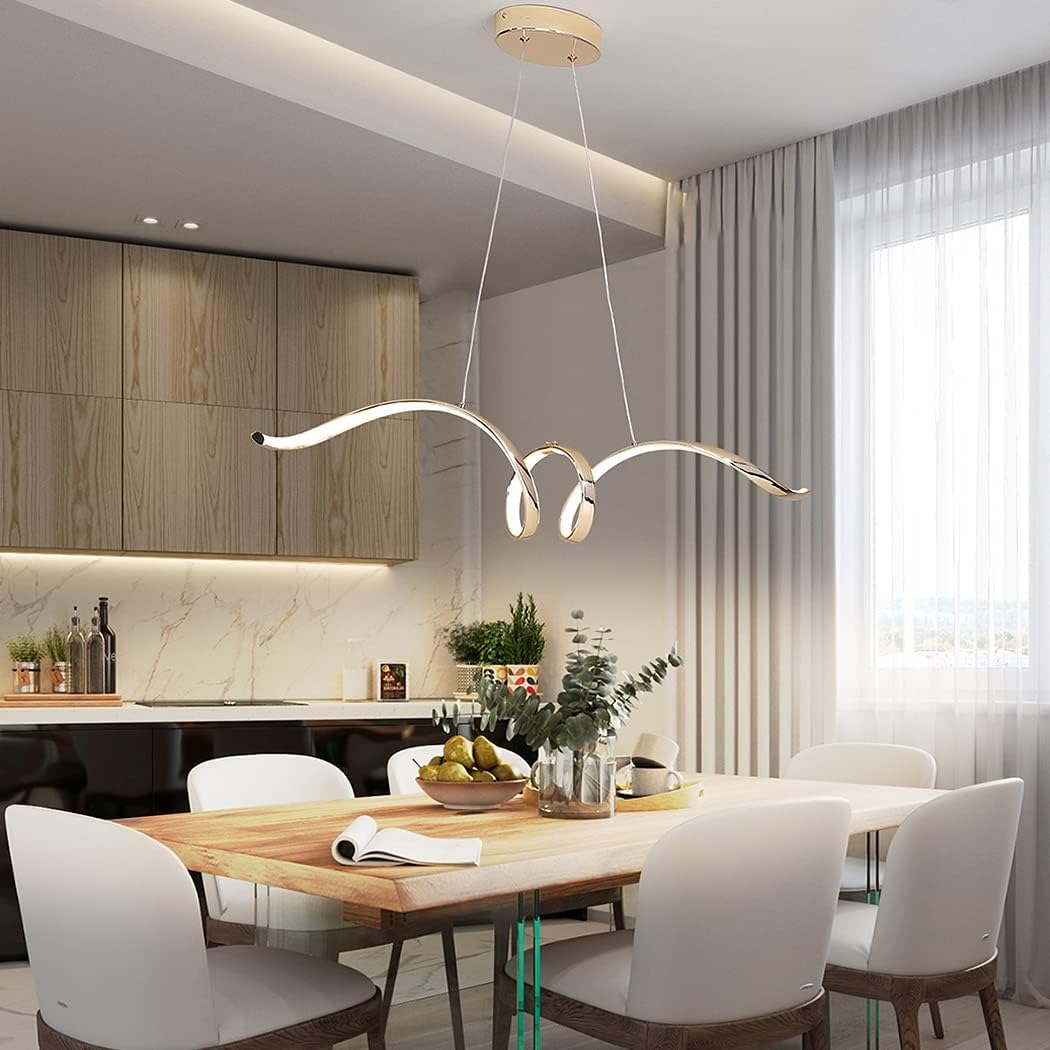 Sculptural aluminium wave pendant light in gold finish over a dining table