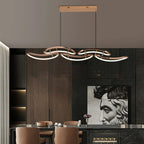 Celvon wavy ribbon LED chandelier — rose gold 145cm over dark marble dining table in luxury interior