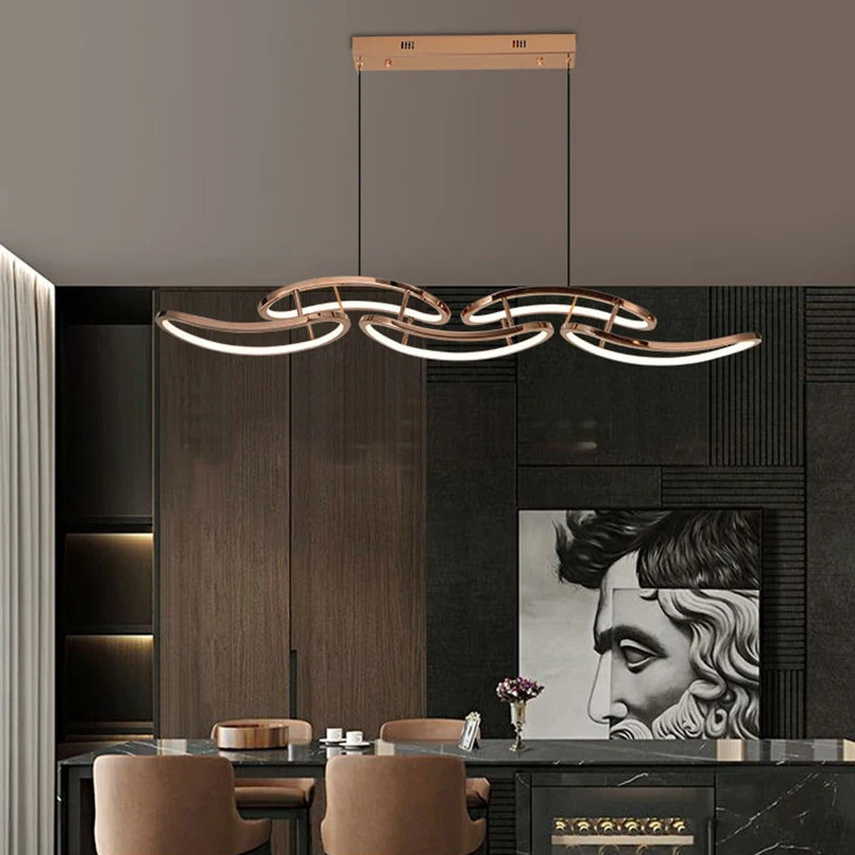 Celvon wavy ribbon LED chandelier — rose gold 145cm over dark marble dining table in luxury interior