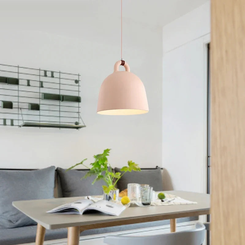 Relavorn resin bell pendant light — Pink finish above a dining nook