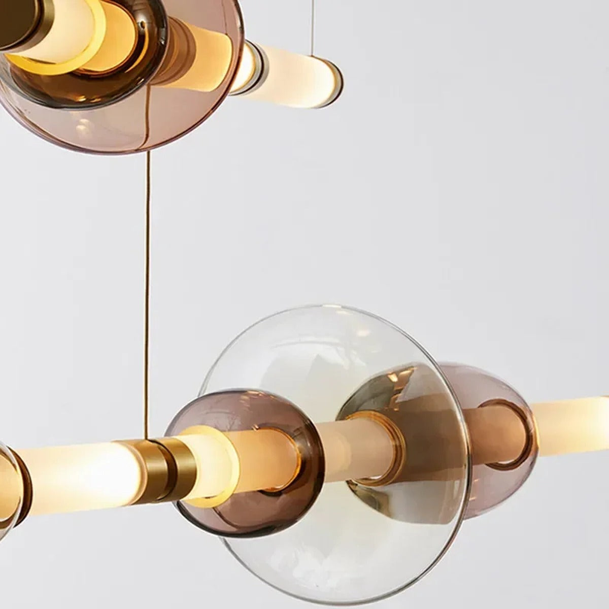 Glass Orb Linear Pendant Light Prismova — Rose Gold combination over minimalist sofa