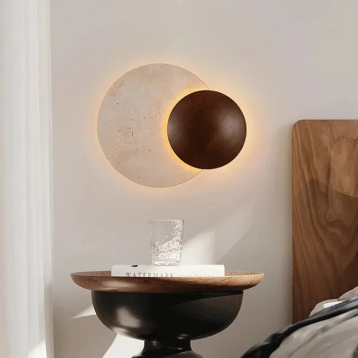 Sculptural Eclipse Wall Sconce Umbrion — bedside table view