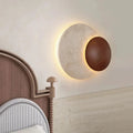 Sculptural Eclipse Wall Sconce Umbrion — lifestyle bedroom view