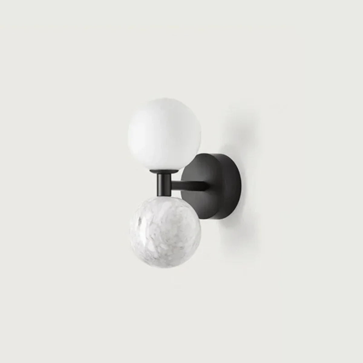 Genival — close-up of marble sphere texture and brass bracket arm