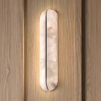 Jenova — pair of gold 65cm sconces flanking bed as bedside lighting