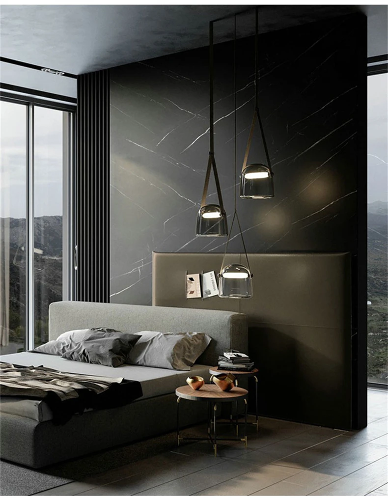 Elorvix smoke gray glass pendant lights staggered above a bedside table in a modern marble bedroom