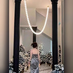 Halmira bead chain pendant illuminating an elegant hallway
