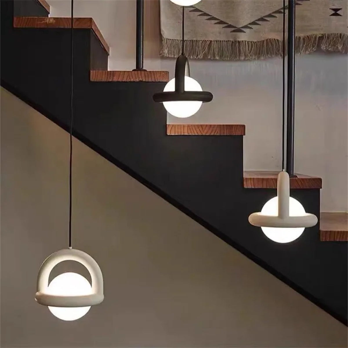 Orbivex — black version beside bedside table at dusk