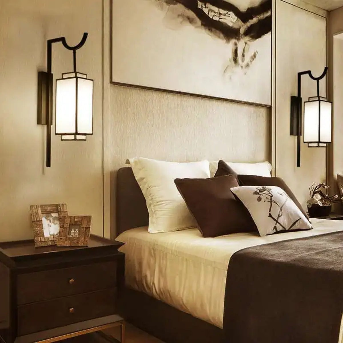 Pair of Luxeva lantern wall sconces in matte black flanking a bed