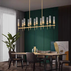 Statement brass linear chandelier with fluted glass shades above a dining table – Cernova