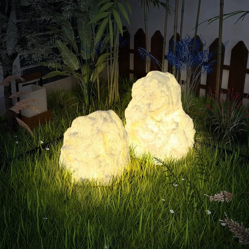 Lumeroc glowing stone lamps in a night garden setting