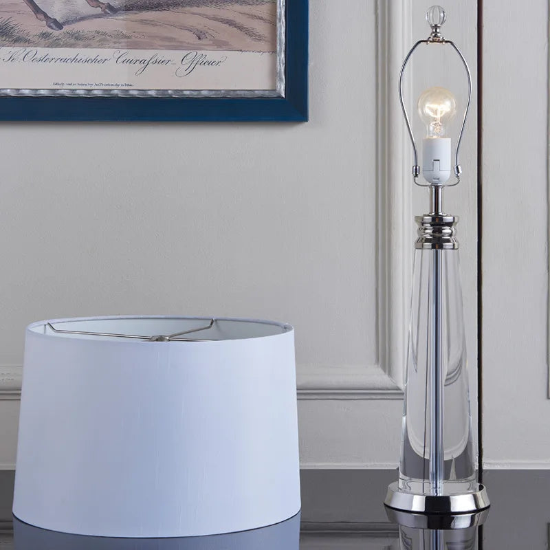 Close-up of the Orindel table lamp's E27 bulb and chrome harp fitting