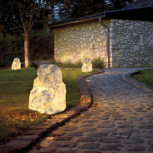 Lumeroc stone-effect lamps glowing along a stone garden path at night