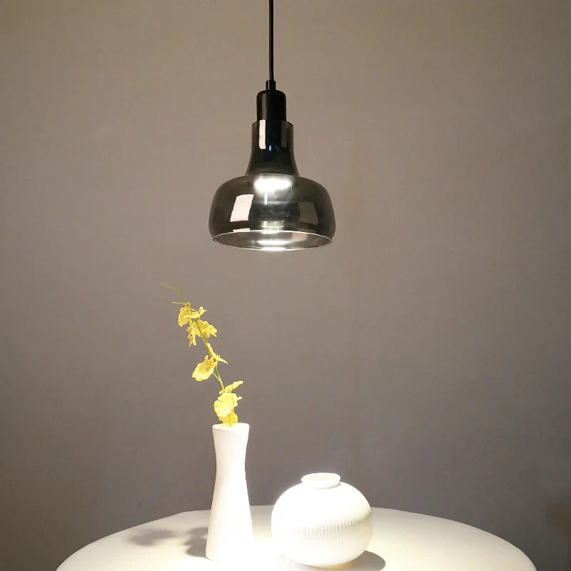 Ozaelix smoked glass pendant – Dome shape (Ø17cm x H15cm) above white side table with orchid vase