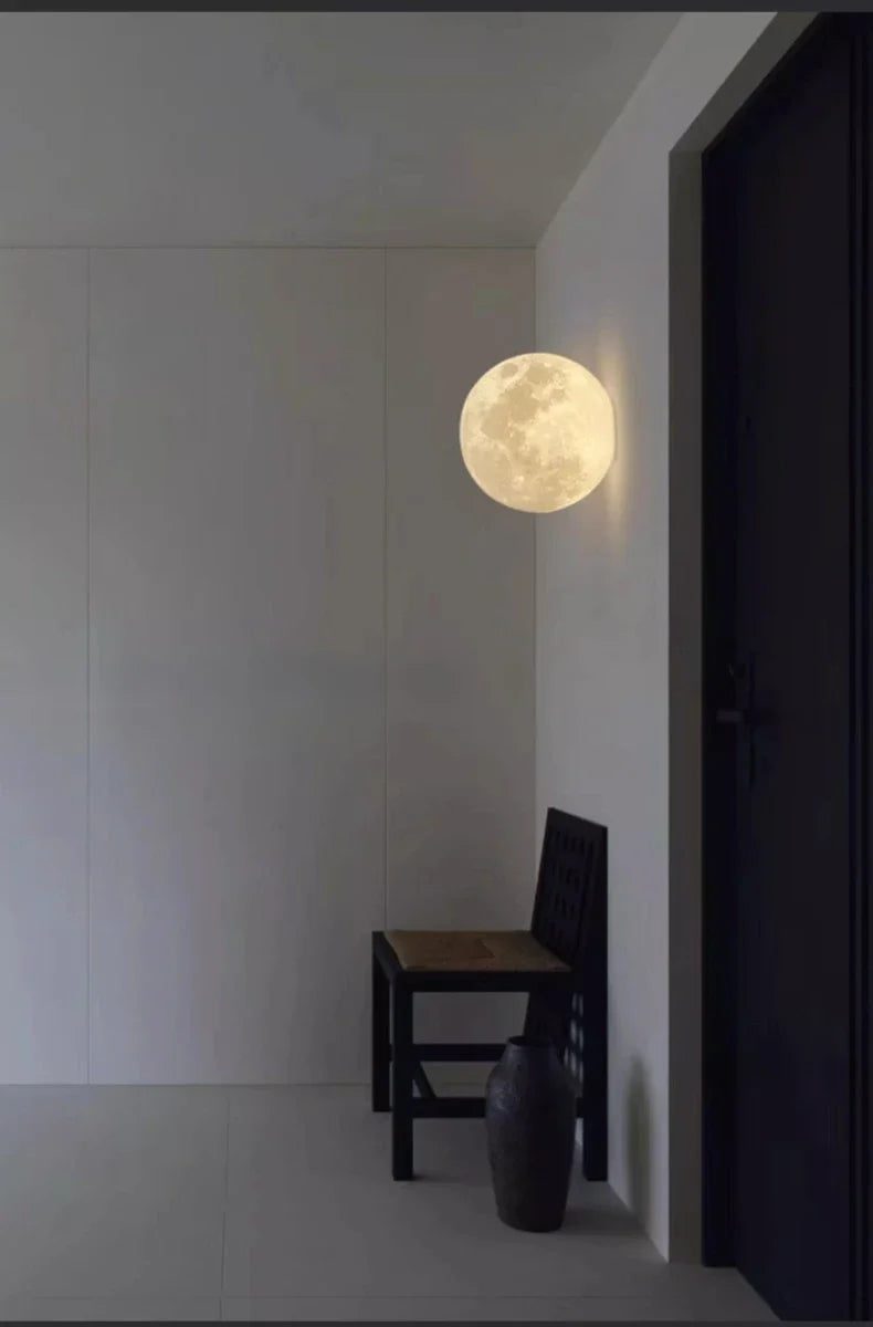 Selenya Whole Sphere lit in an entryway beside a wooden chair