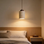 Owaelindra travertine pendant light hanging warm above a bed