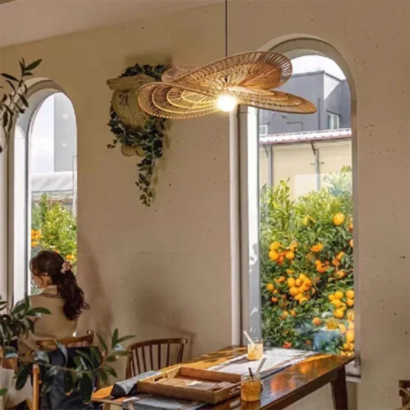 Lotara Lotus twisted rattan pendant in a café setting with arched windows