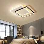 Orvena square ceiling light glowing warm above a bedroom with mustard and grey cushions