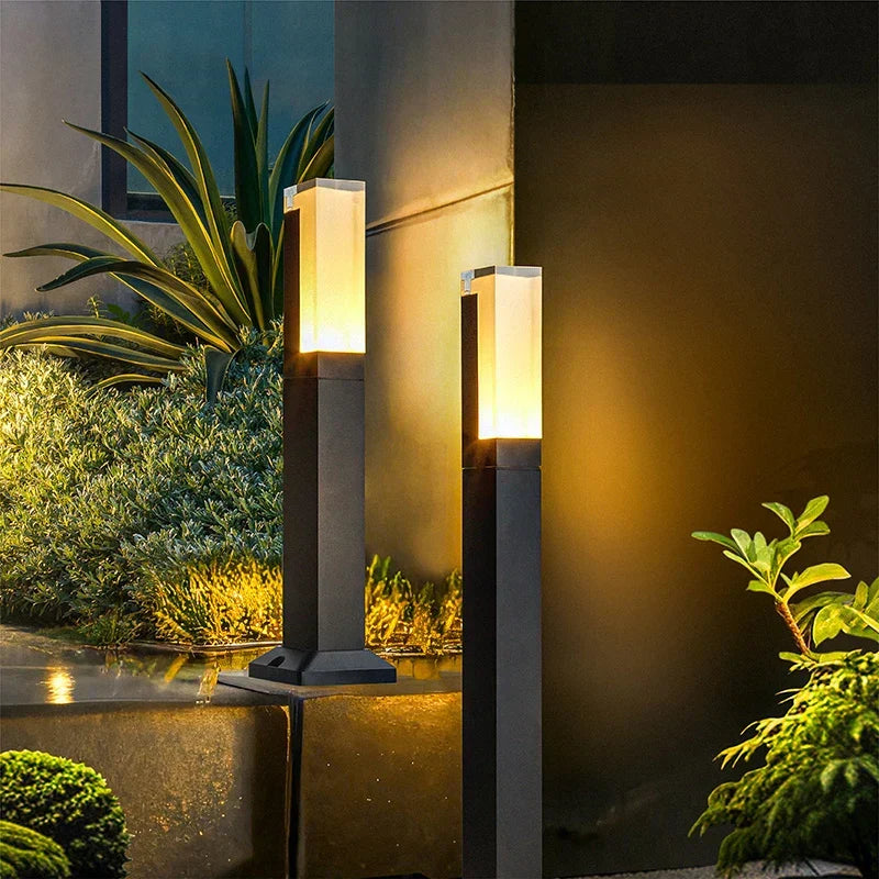 Modern Aluminium Garden Path Light Evmora - illuminated at night beside a modern facade