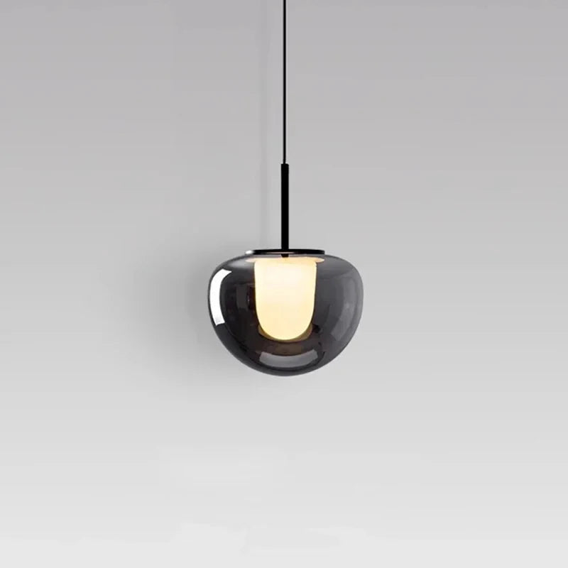 Mzaelvix glass globe pendant – smoke grey finish above bedside table, warm light